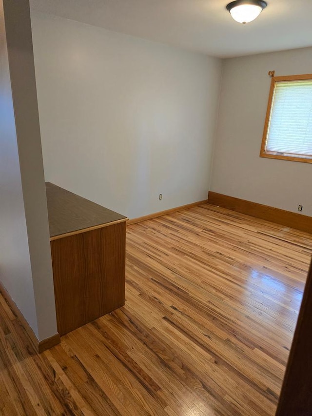 spare room with light hardwood / wood-style floors