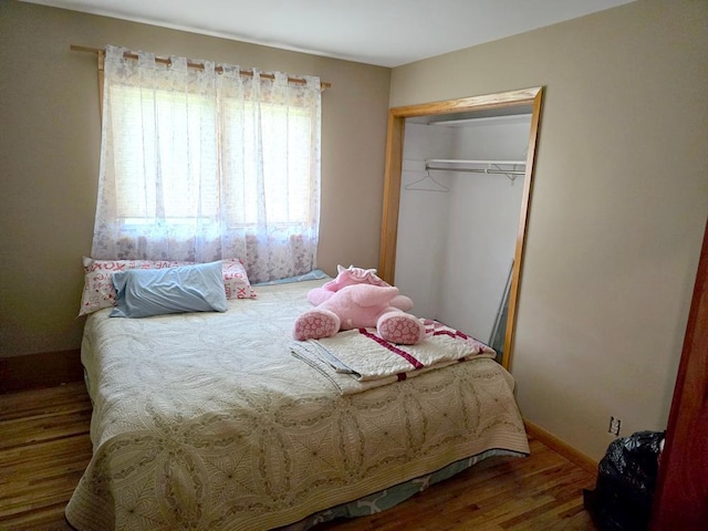 bedroom with hardwood / wood-style flooring and a closet