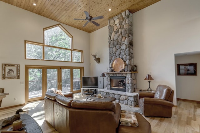 living room with high vaulted ceiling, ceiling fan, light wood-type flooring, a fireplace, and wood ceiling