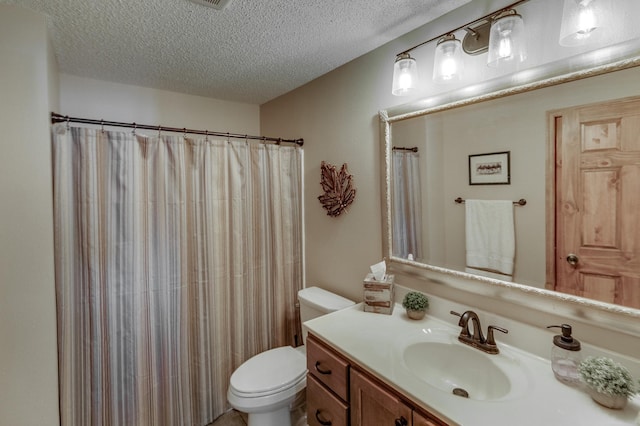 bathroom featuring a shower with shower curtain, vanity, toilet, and a textured ceiling