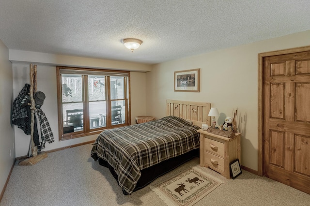 bedroom featuring light carpet and a textured ceiling