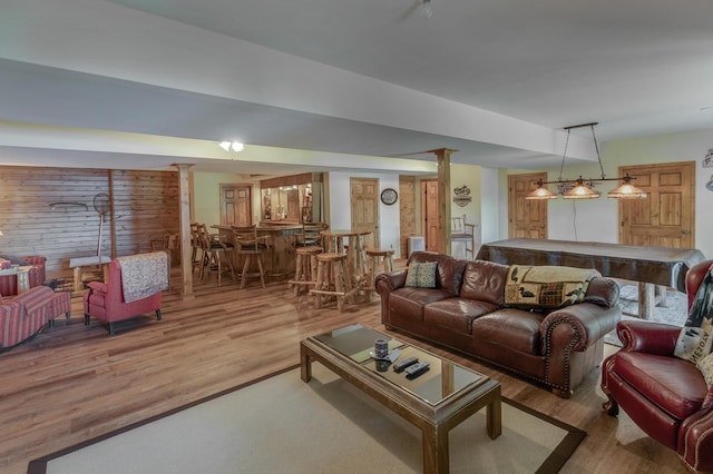 living room featuring bar area and hardwood / wood-style flooring