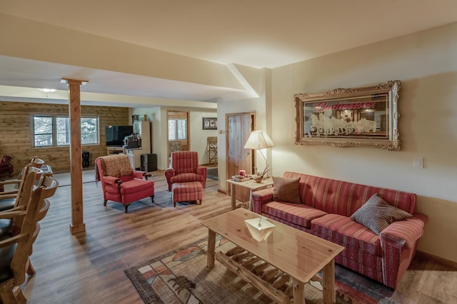 living room with hardwood / wood-style floors, decorative columns, and french doors