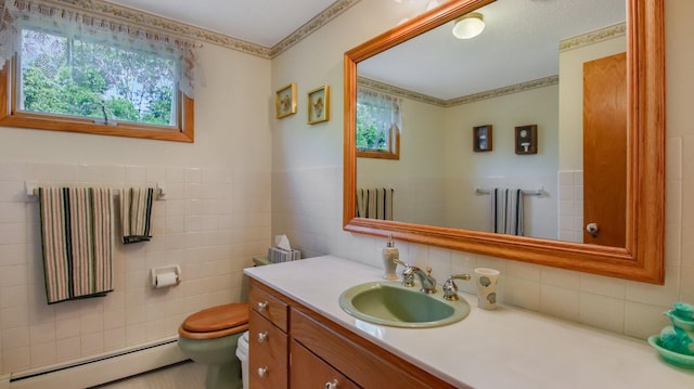 bathroom featuring tile walls, a baseboard heating unit, vanity, and toilet