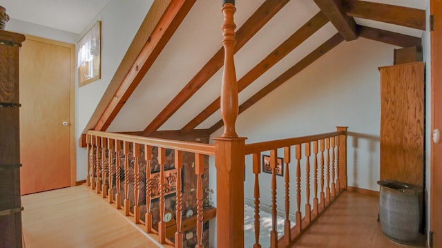 hallway with vaulted ceiling with beams and light hardwood / wood-style flooring