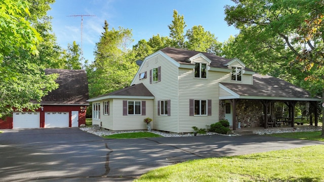 cape cod house featuring a garage, a front lawn, and covered porch