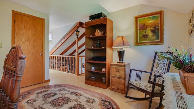 sitting room with lofted ceiling and light hardwood / wood-style flooring