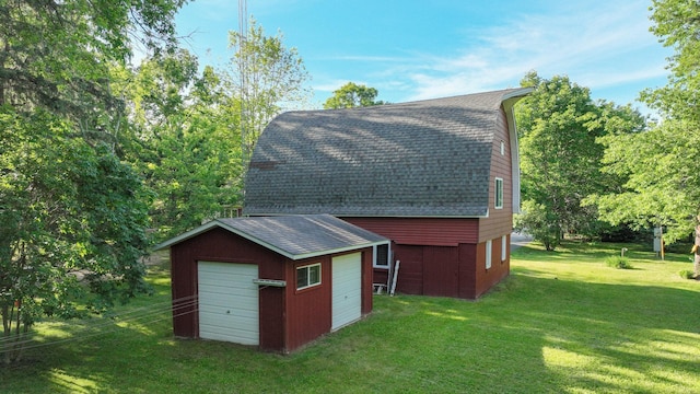 view of outbuilding featuring a garage and a lawn