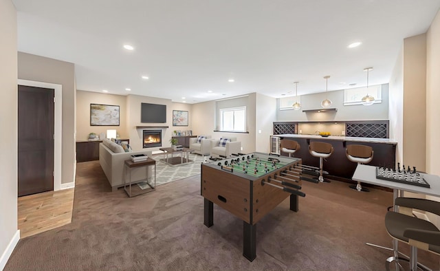 7106 Valley View Rd, Edina, MN 55439 - game room with carpet floors, recessed lighting, a warm lit fireplace, baseboards, and an office area