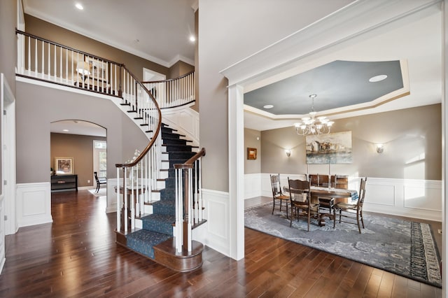 interior space featuring a notable chandelier, hardwood / wood-style flooring, and crown molding