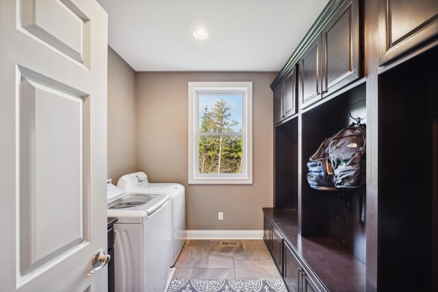 laundry area featuring washing machine and dryer and cabinets