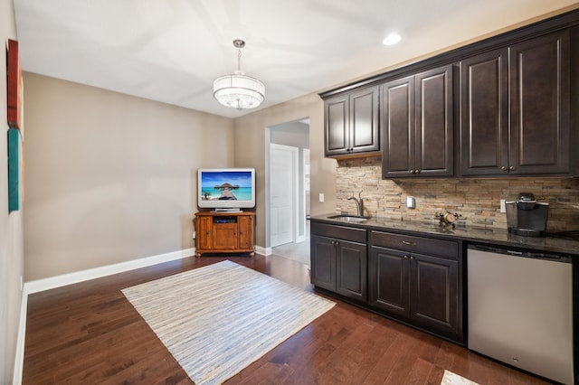 kitchen with decorative backsplash, dishwasher, dark hardwood / wood-style flooring, an inviting chandelier, and sink