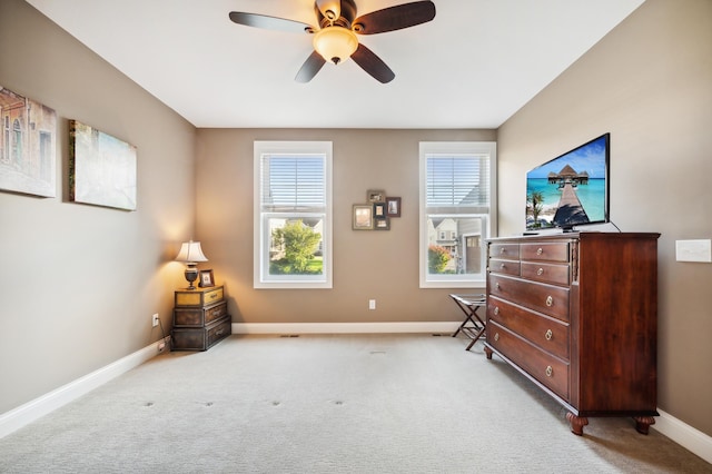 living area featuring light carpet and ceiling fan