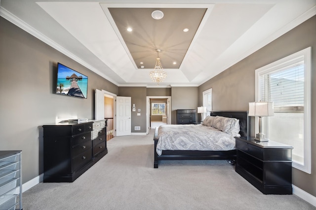 carpeted bedroom with an inviting chandelier, a raised ceiling, and crown molding