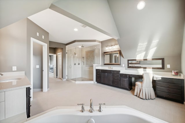 bathroom with vanity and shower with separate bathtub