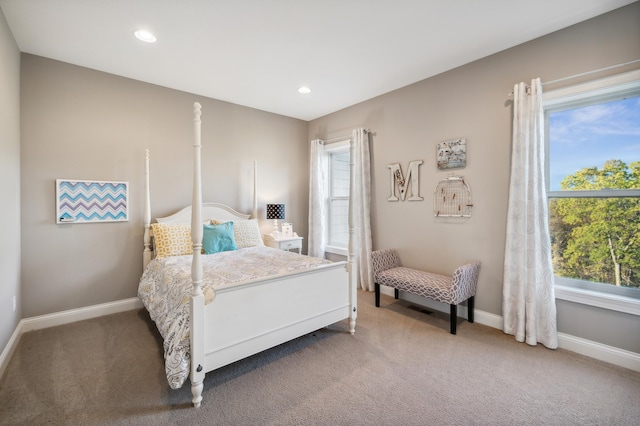 bedroom with carpet flooring and multiple windows