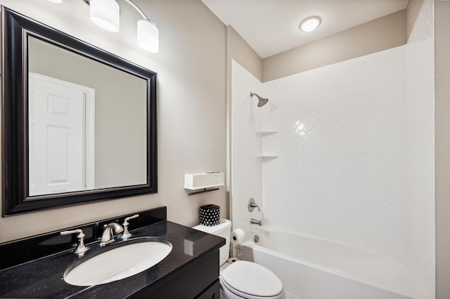 full bathroom with vanity, tiled shower / bath combo, and toilet