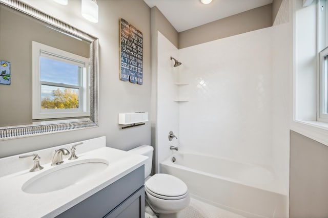 full bathroom featuring tiled shower / bath combo, vanity, and toilet