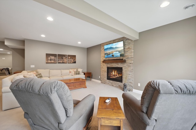 living room with light carpet, beamed ceiling, and a fireplace