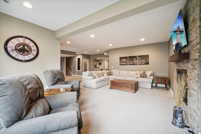 living room featuring carpet flooring and a stone fireplace