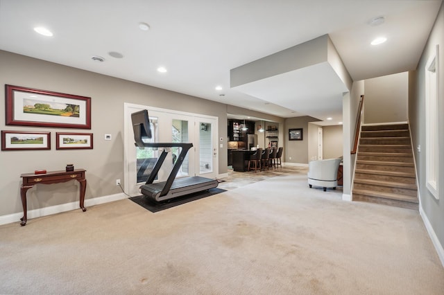 exercise area with light carpet and bar area