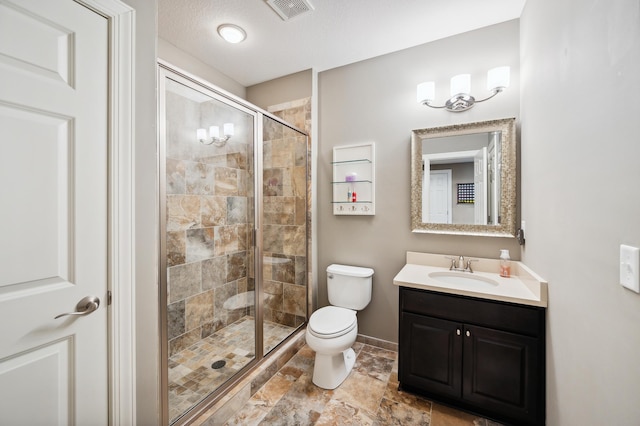 bathroom with a textured ceiling, an enclosed shower, vanity, and toilet