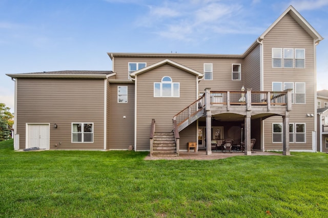 back of house featuring a wooden deck, a yard, and a patio area