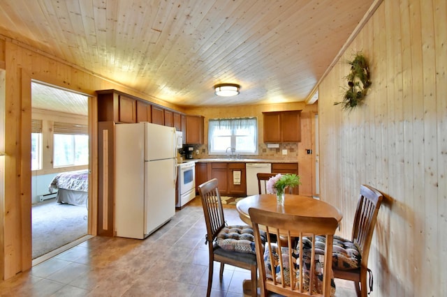 46350 Cambridge Dr, Stanchfield, MN 55080 - dining space featuring wooden walls, light tile patterned floors, a baseboard heating unit, and wooden ceiling