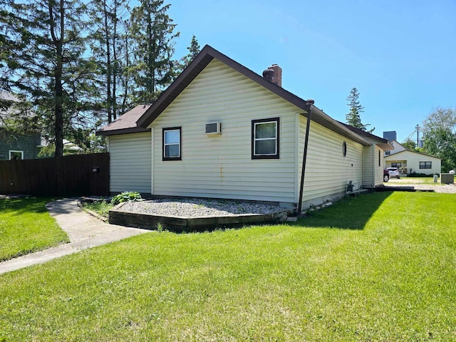 view of side of home featuring a lawn