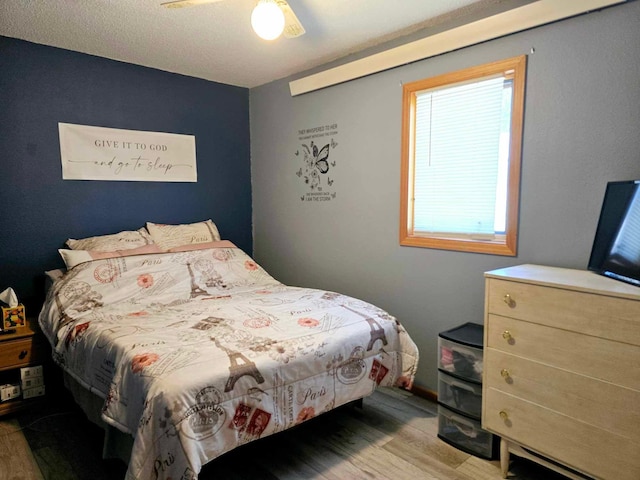 bedroom with light hardwood / wood-style flooring and ceiling fan