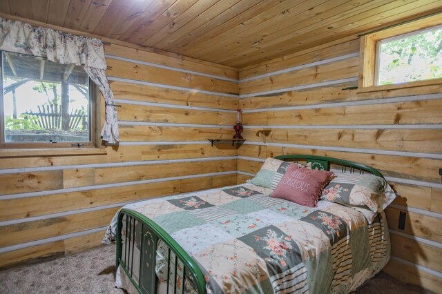 carpeted bedroom featuring multiple windows and wooden ceiling