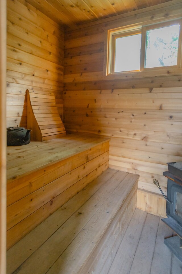 view of sauna featuring wood walls, hardwood / wood-style flooring, and wood ceiling