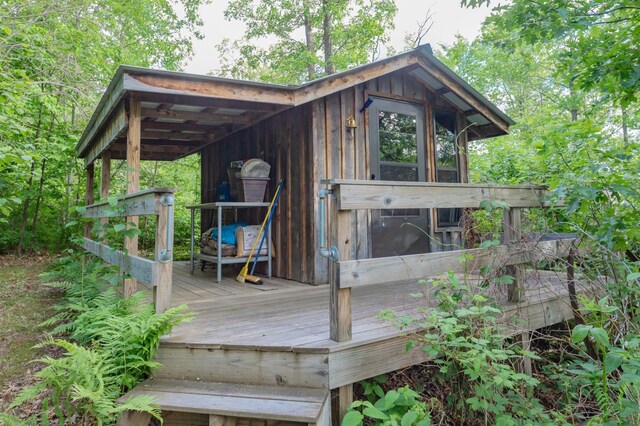 wooden terrace featuring an outdoor structure