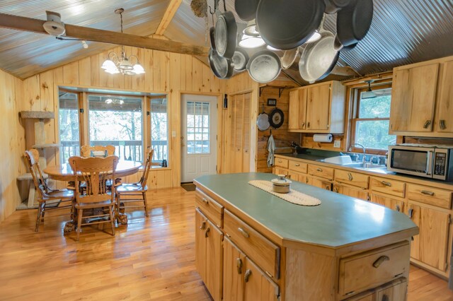 kitchen featuring wood walls, plenty of natural light, and a center island