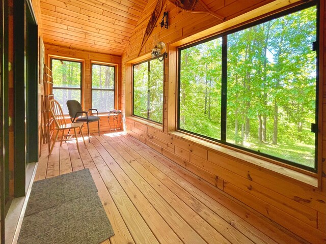 unfurnished sunroom featuring wooden ceiling and lofted ceiling