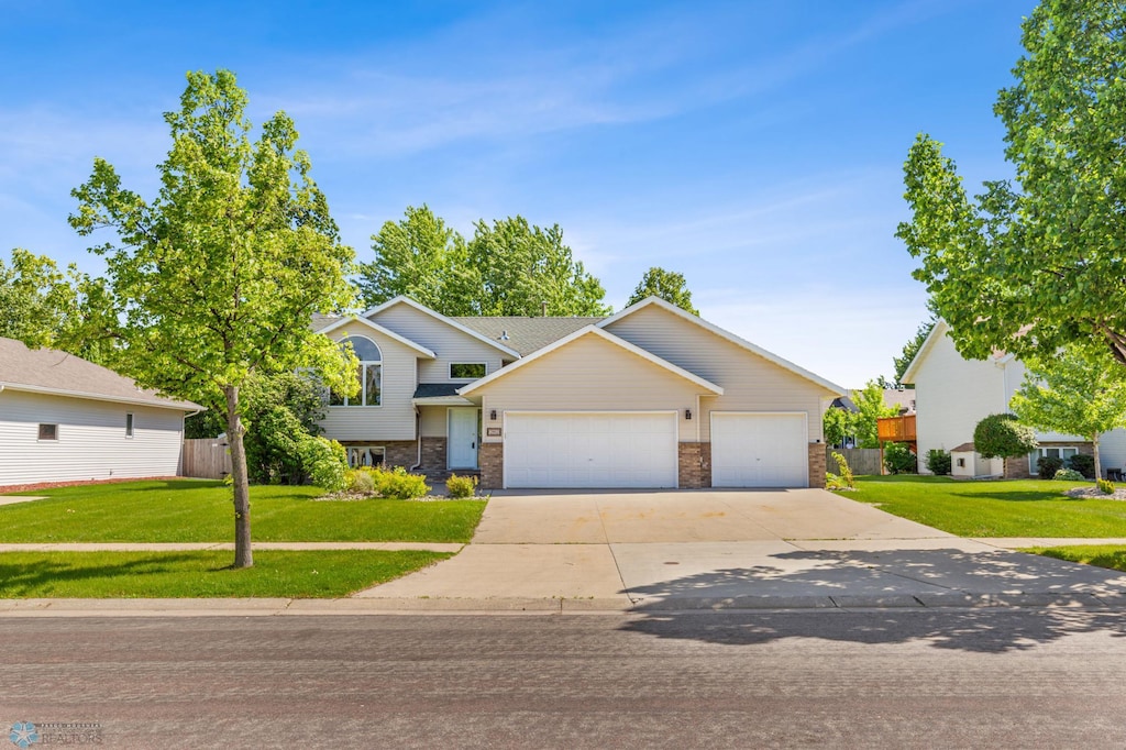 view of front of house with a garage and a front yard