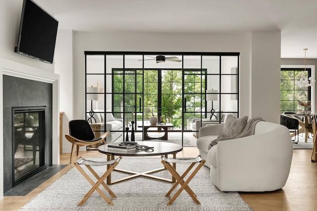 sitting room with ceiling fan and light hardwood / wood-style flooring