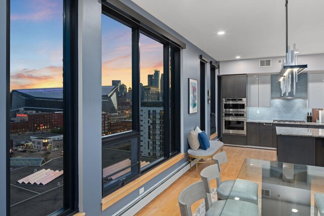 1240 2nd St Unit 1201, Minneapolis, MN 55415 - kitchen with modern cabinets, light wood-style flooring, a view of city, stainless steel appliances, and recessed lighting