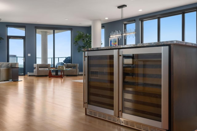 1240 2nd St Unit 1201, Minneapolis, MN 55415 - bar area with wood finished floors, beverage cooler, recessed lighting, and hanging light fixtures