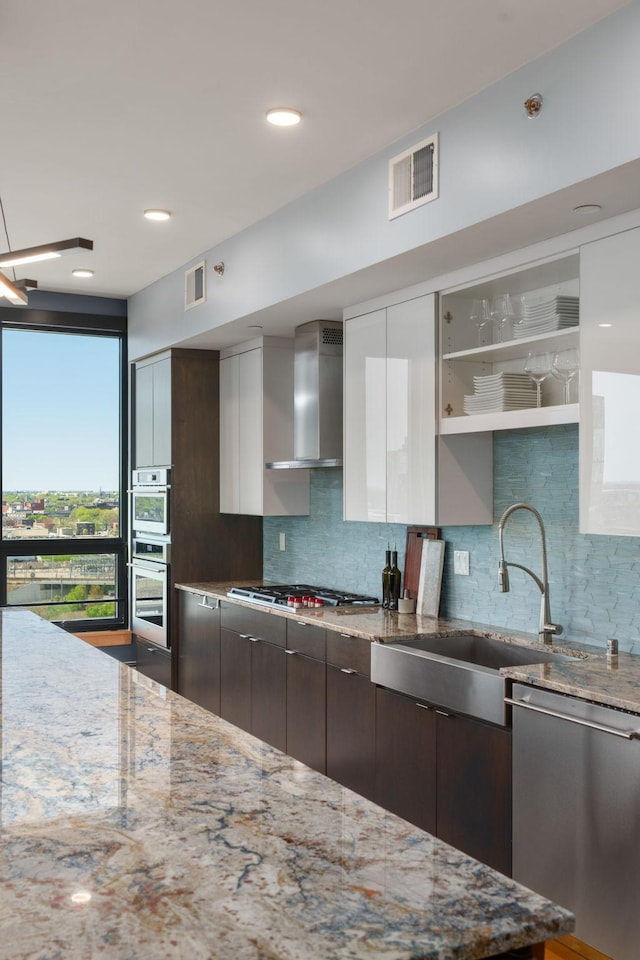 1240 2nd St Unit 1201, Minneapolis, MN 55415 - kitchen with stainless steel appliances, wall chimney range hood, modern cabinets, tasteful backsplash, and dark brown cabinets