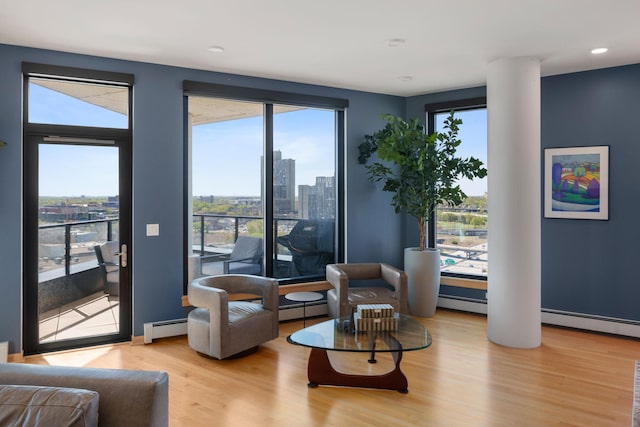 1240 2nd St Unit 1201, Minneapolis, MN 55415 - living area featuring wood finished floors, a view of city, plenty of natural light, baseboard heating, and recessed lighting