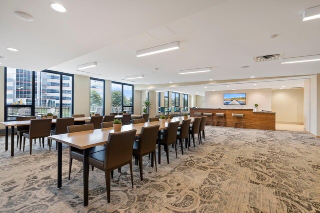 1240 2nd St Unit 1201, Minneapolis, MN 55415 - dining area featuring light colored carpet, floor to ceiling windows, and recessed lighting