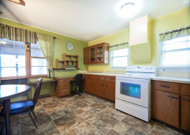 kitchen with white range with electric cooktop and a wealth of natural light