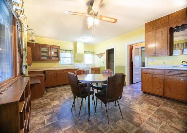 dining room featuring ceiling fan and sink