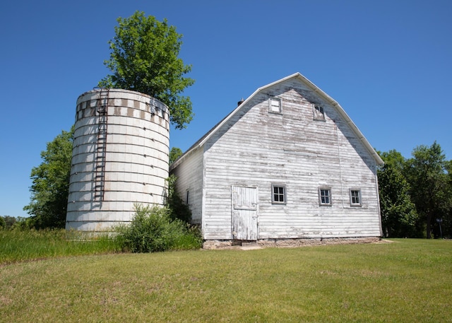 view of side of home with a lawn