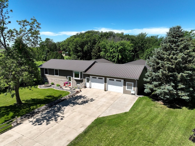 ranch-style house featuring a garage and a front lawn