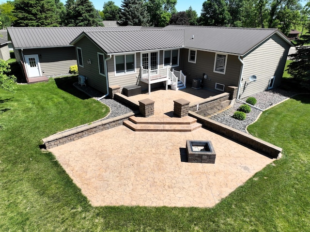 back of property with a yard, a patio area, and central air condition unit