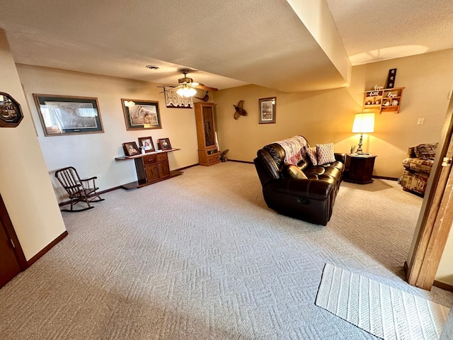 carpeted living room with ceiling fan and a textured ceiling