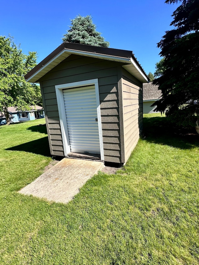 view of outbuilding with a lawn