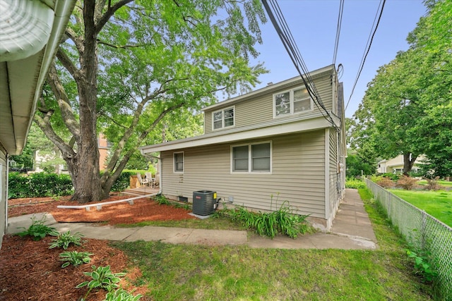 rear view of property with central AC unit